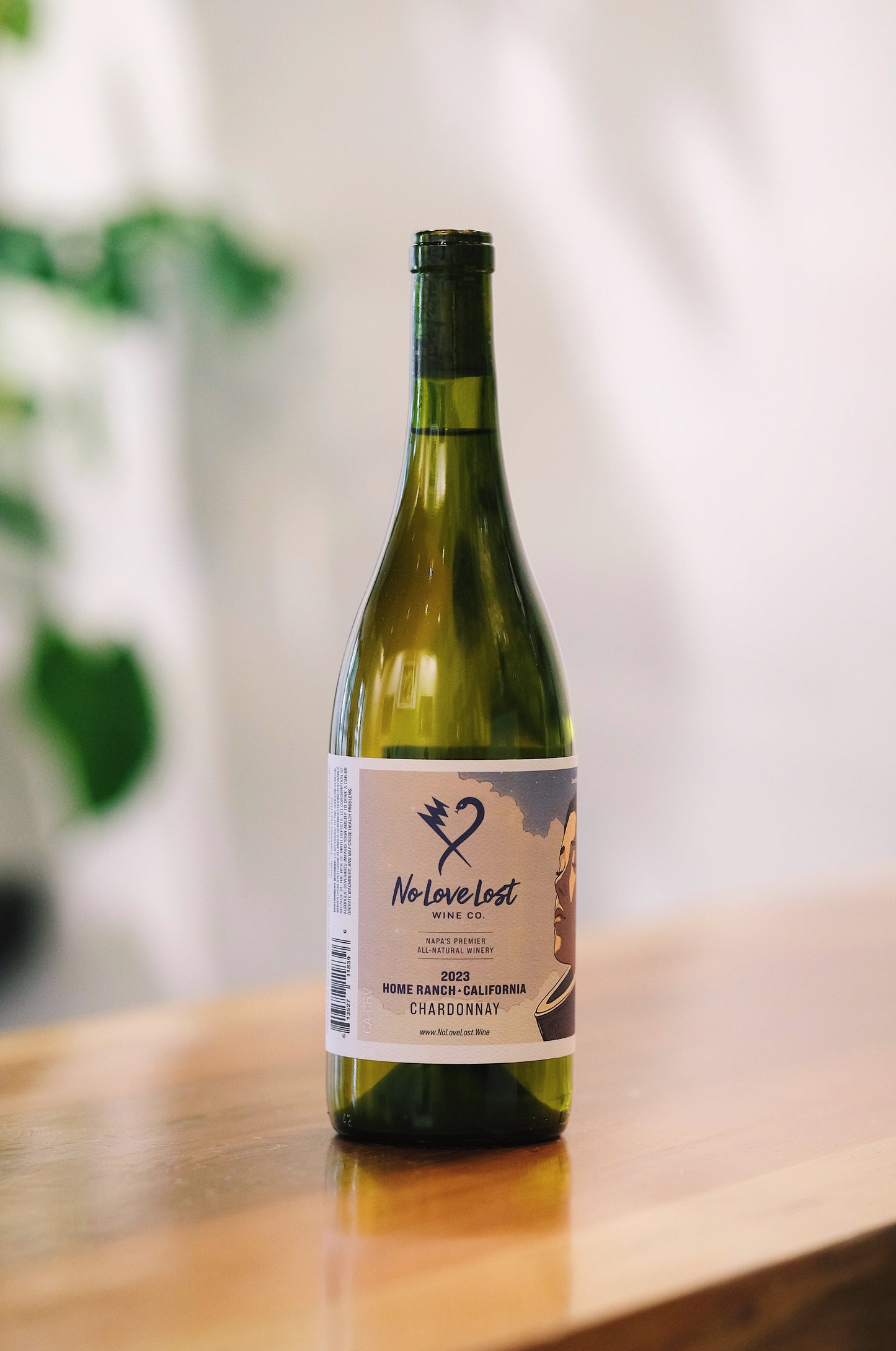 Bottle of No Love Lost 2023 Home Ranch Chardonnay natural wine, featuring vibrant notes of orchard fruits, subtle minerality, and a bright and crisp, natural winemaking style for Chardonnay enthusiasts.