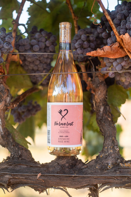 2023 No Love Lost Rosé — organic family-owned vineyard on east Lodi, sustainably farmed and CCOF certified. Grenache clones Entav & Davis, lightly foot-treaded, tank fermented, aged 6 months in neutral Loire oak. Aromas of watermelon rind, strawberry, and stone fruit; ripe peach palate with bright, long-lasting acidity. 12.1% ABV.