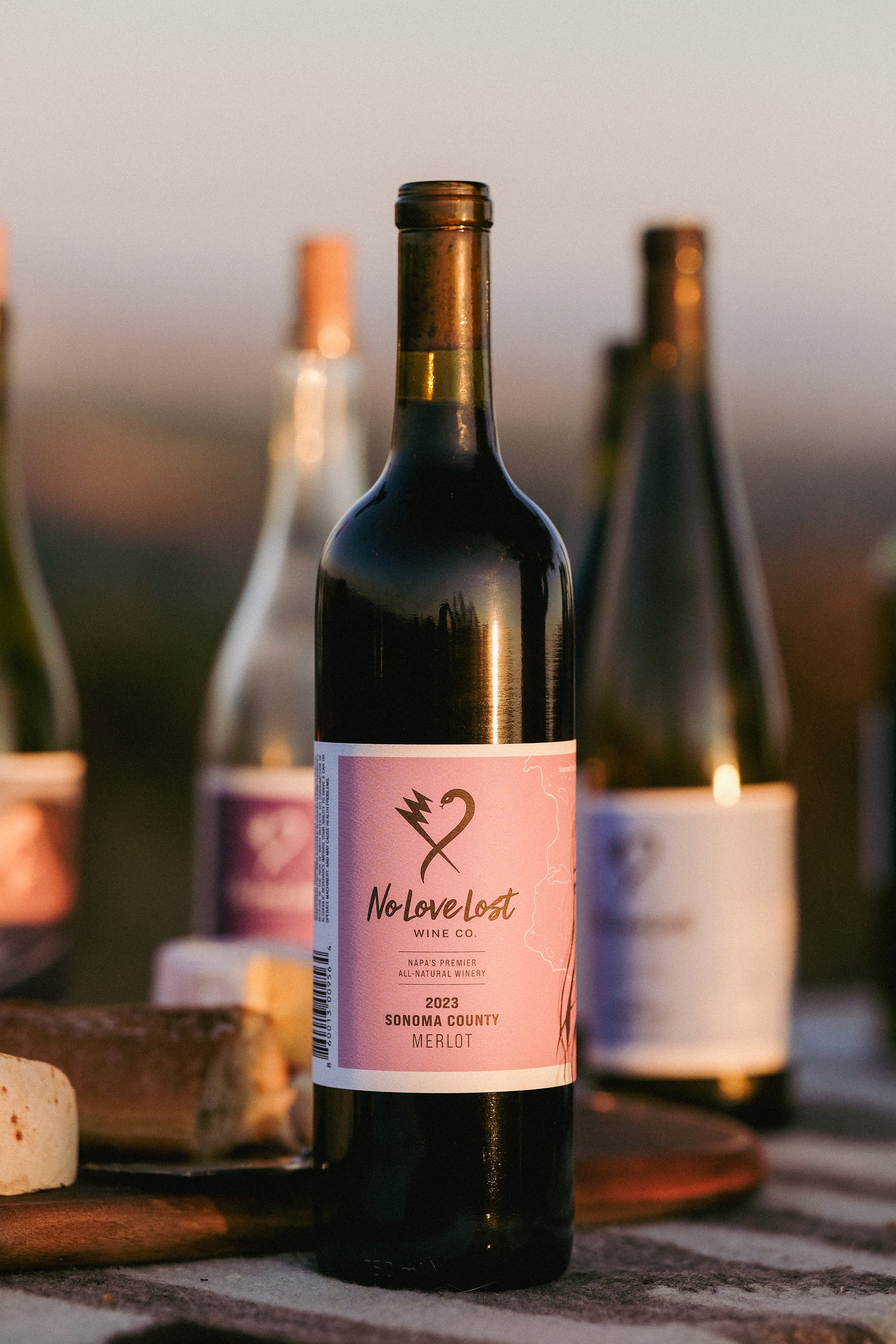 2023 No Love Lost Sonoma Merlot — Alexander Valley Geyser Vista vineyard, grown in volcanic mineral-rich soils with coastal breezes. Native yeast fermentation, savory layers of red cherry, wild berry, sage, bay leaf, spice, and crushed stone. Elegant, complex, and mineral-driven Merlot. 13.2% ABV.