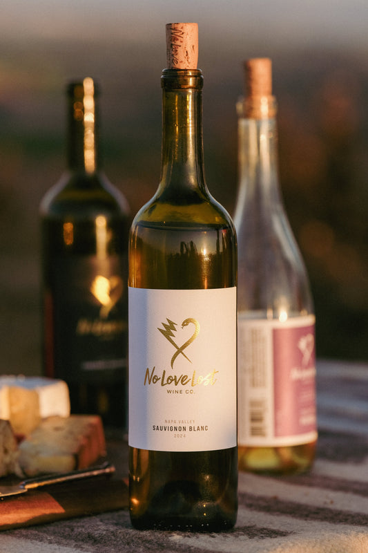 2024 No Love Lost Napa Valley Sauvignon Blanc — Saint Helena AVA single-vineyard wine grown on deep alluvial clay soils. Whole cluster pressed, stainless steel fermented, aged 6 months in neutral Loire oak. Tropical guava and passionfruit with yellow peach, Valencia orange, and zesty acidity. 12.6% ABV.