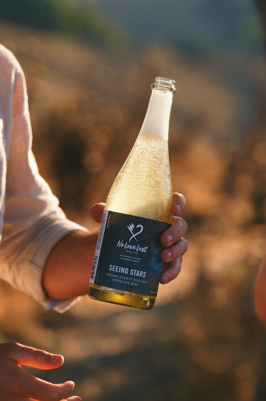 2024 No Love Lost Sparkling Riesling — Dry Creek Valley AVA, Sonoma County. East-facing vineyard above the fog line with blue slate soils and cool Pacific influence. Brioche, stone fruit, pineapple, and petrol notes with lively effervescence. Versatile natural sparkling wine, pairs with salads, ribeye, or desserts. 11.9% ABV.